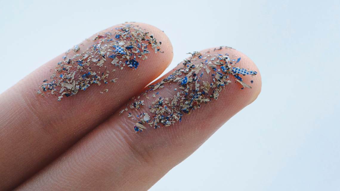 Close up side shot of microplastics lay on people hand