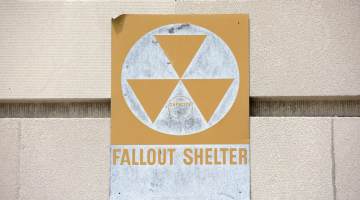 yellow fallout shelter sign on a building